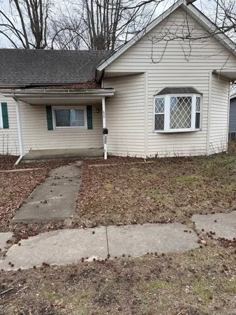 a house that has a tree in front of it