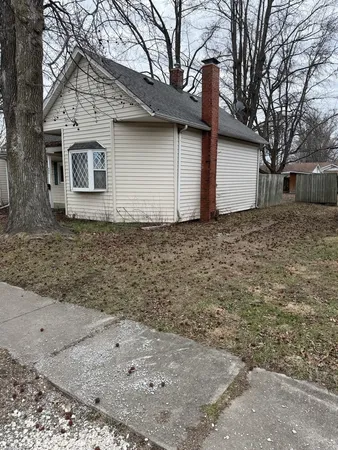 a house that has a tree in front of it