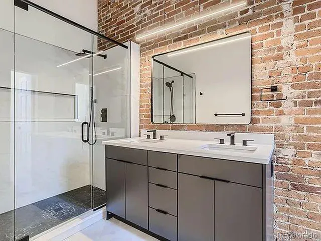 a bathroom with a double vanity sink a mirror and shower