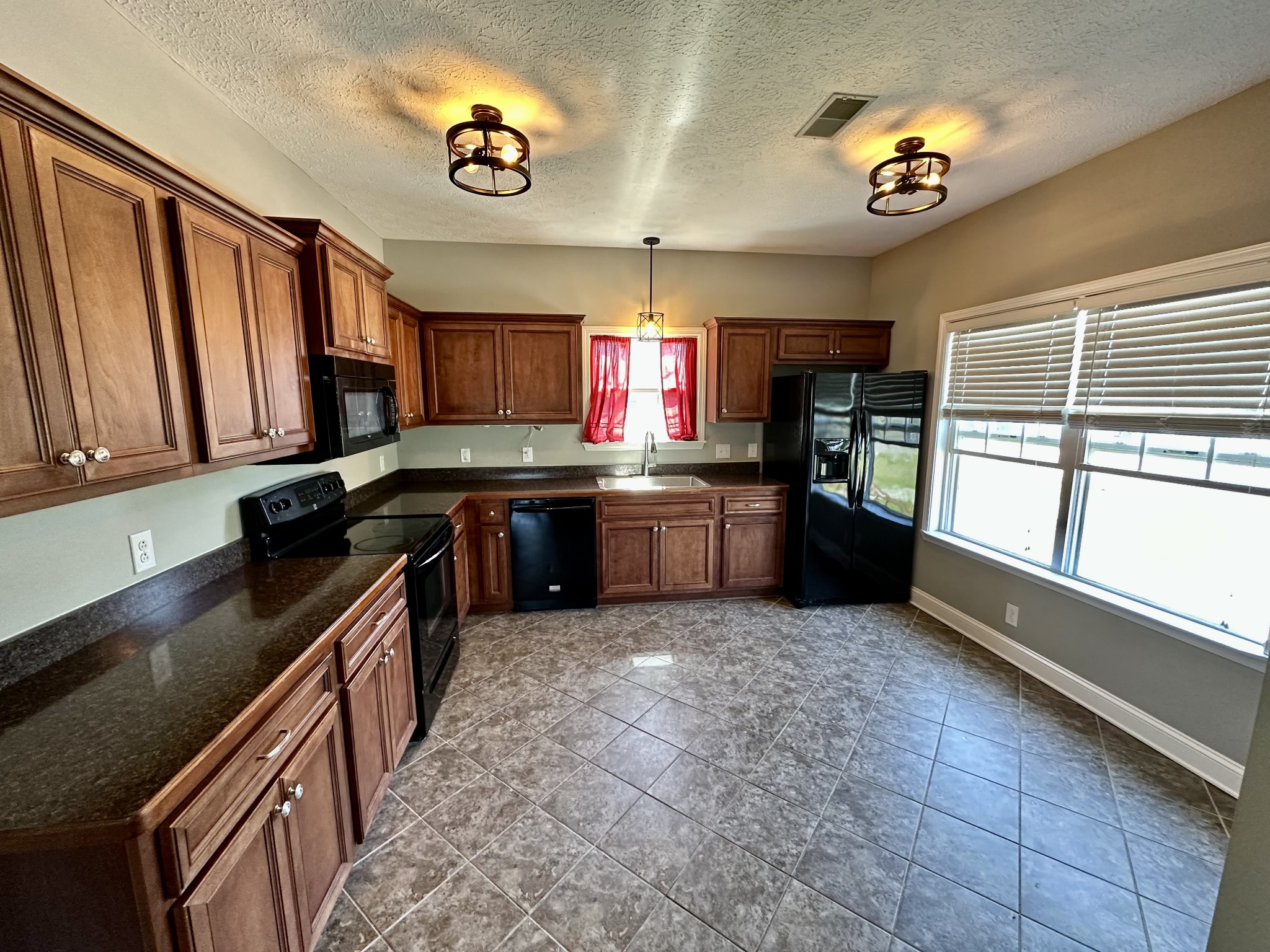 583 Neelys Bend Road Madison, TN 37115 - Photo 8 of 21 a kitchen with stainless steel appliances granite countertop a sink stove and cabinets