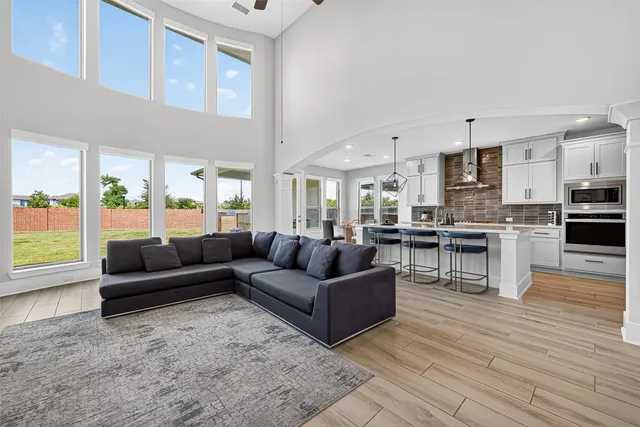 a living room with furniture and kitchen view