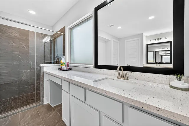 a bathroom with a double vanity sink and a mirror