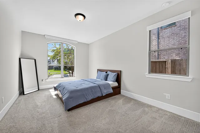 a bed room with a bed and a window