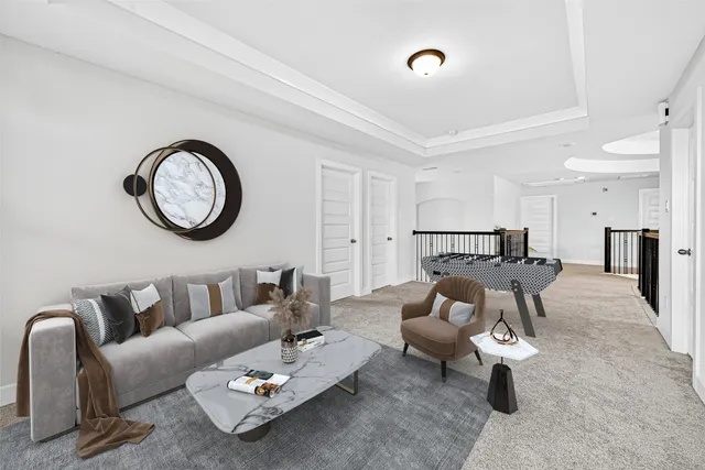 a living room with furniture and a clock