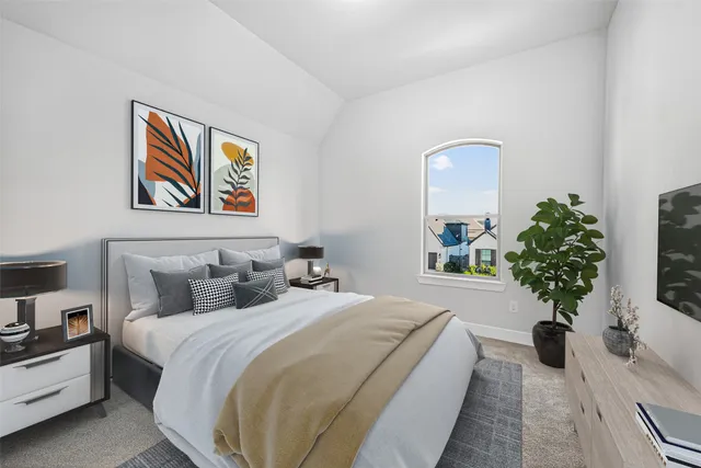 a spacious bedroom with bed and a potted plant