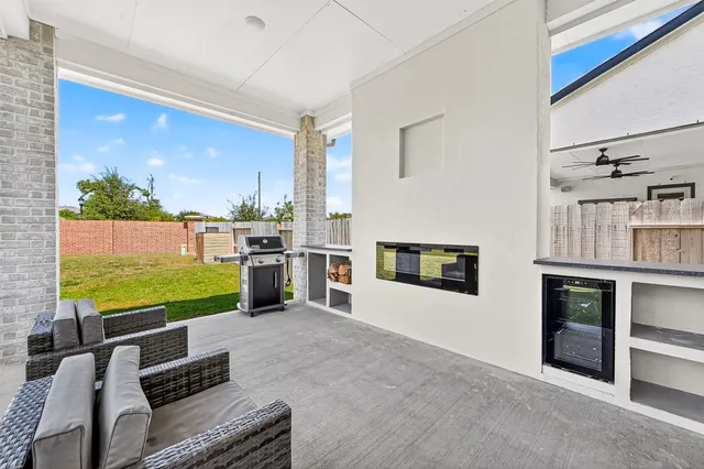 a open kitchen with granite countertop a stove top oven a sink and dishwasher a oven with wooden floor