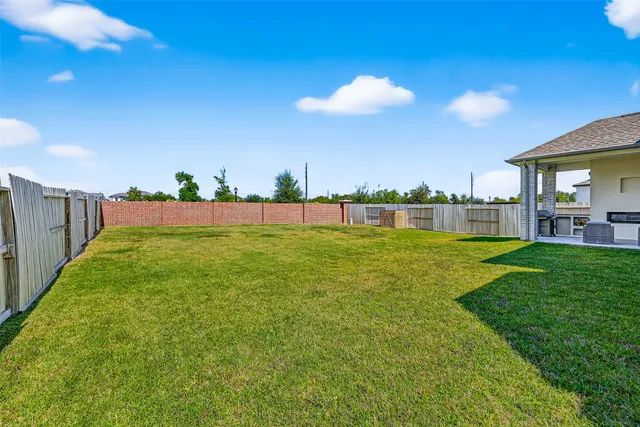 a view of yard with swimming pool and green space
