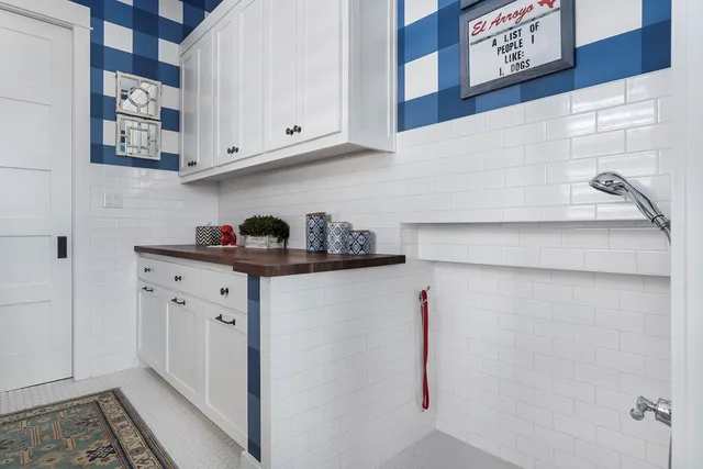 a spacious bedroom with a bed and wooden floor