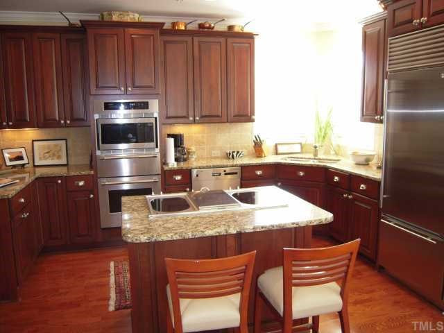 3700 Baron Cooper Pass, Unit 201 Raleigh, NC 27612 - Photo 6 of 12 Kitchen Has Center Island With Smooth Cooktop and Grill, Stainless Steel Appliances and Granite Countertops (Refrigerator does not convey) Kitchen