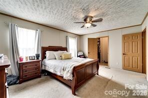 179 Fresh Water Rdg Road Whittier, NC 28789 - Photo 22 of 48 a bedroom with a bed lamp and a chandelier