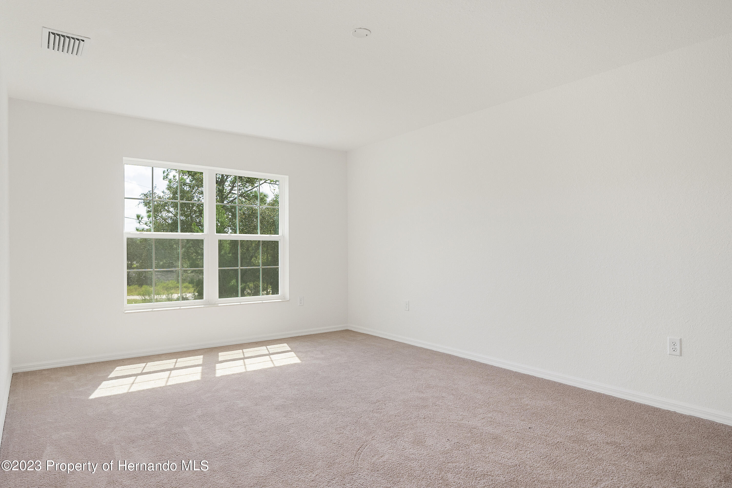 8433 Nightingale Road Weeki Wachee, FL 34613 - Photo 11 of 23 an empty room with a window