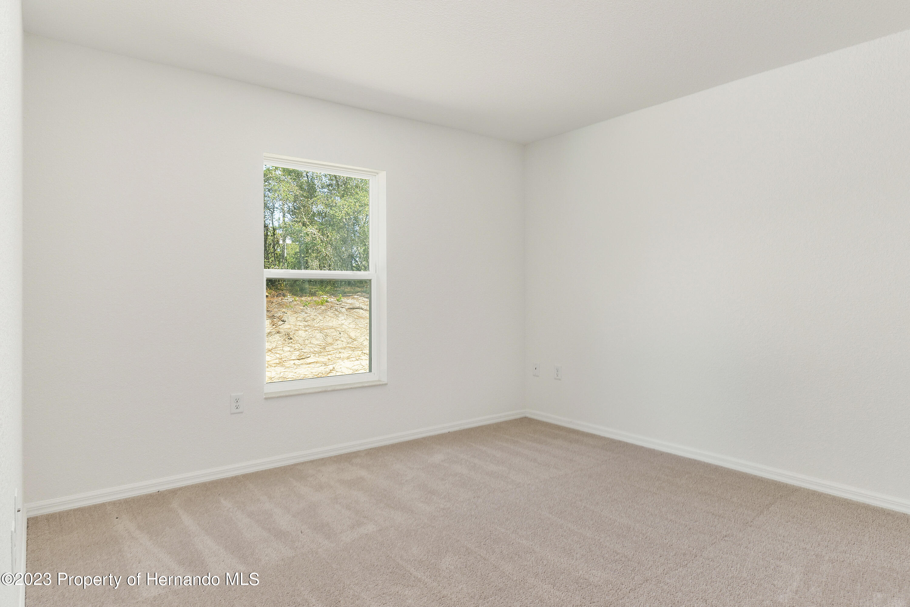 8433 Nightingale Road Weeki Wachee, FL 34613 - Photo 13 of 23 an empty room with a window