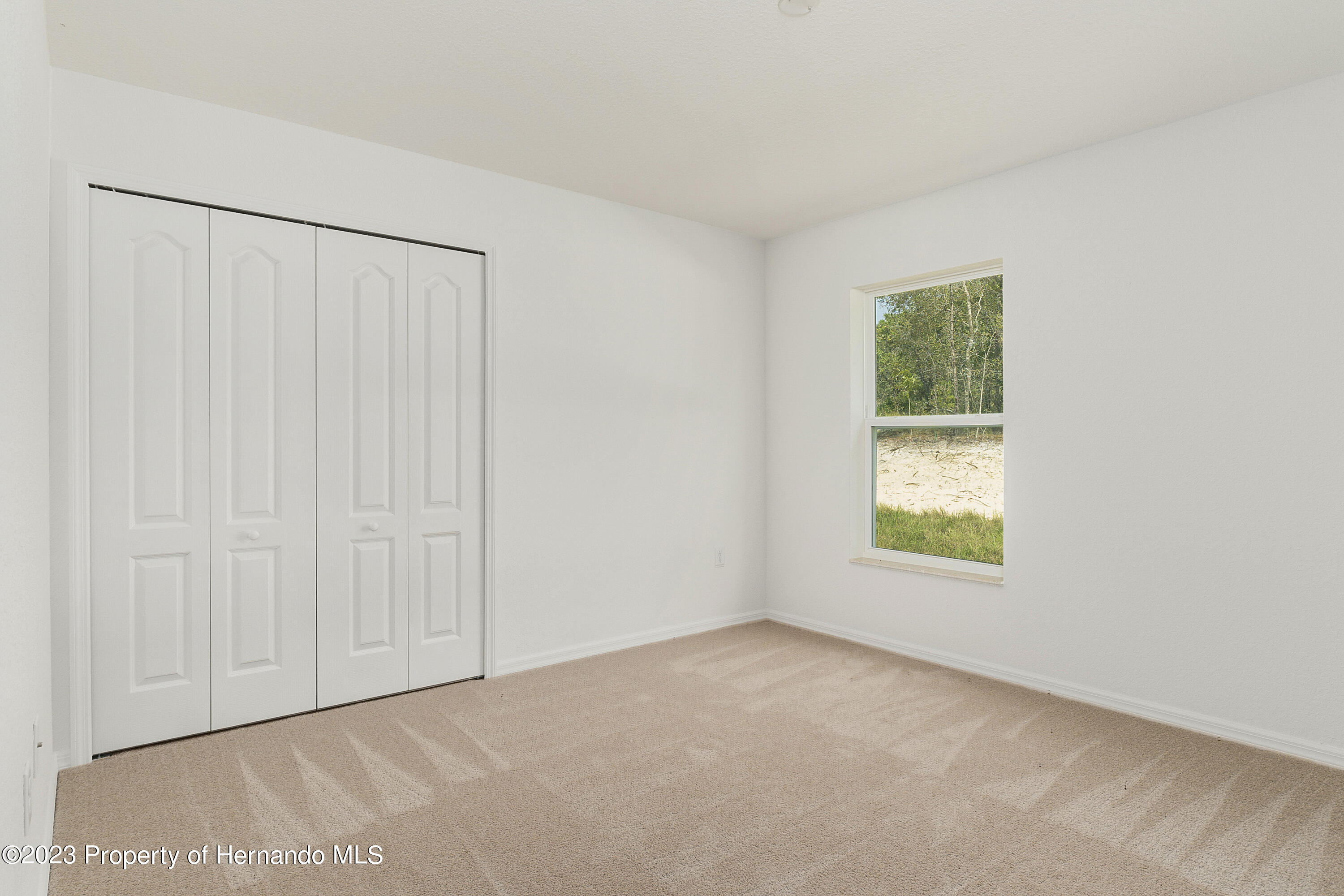 8433 Nightingale Road Weeki Wachee, FL 34613 - Photo 14 of 23 an empty room with windows