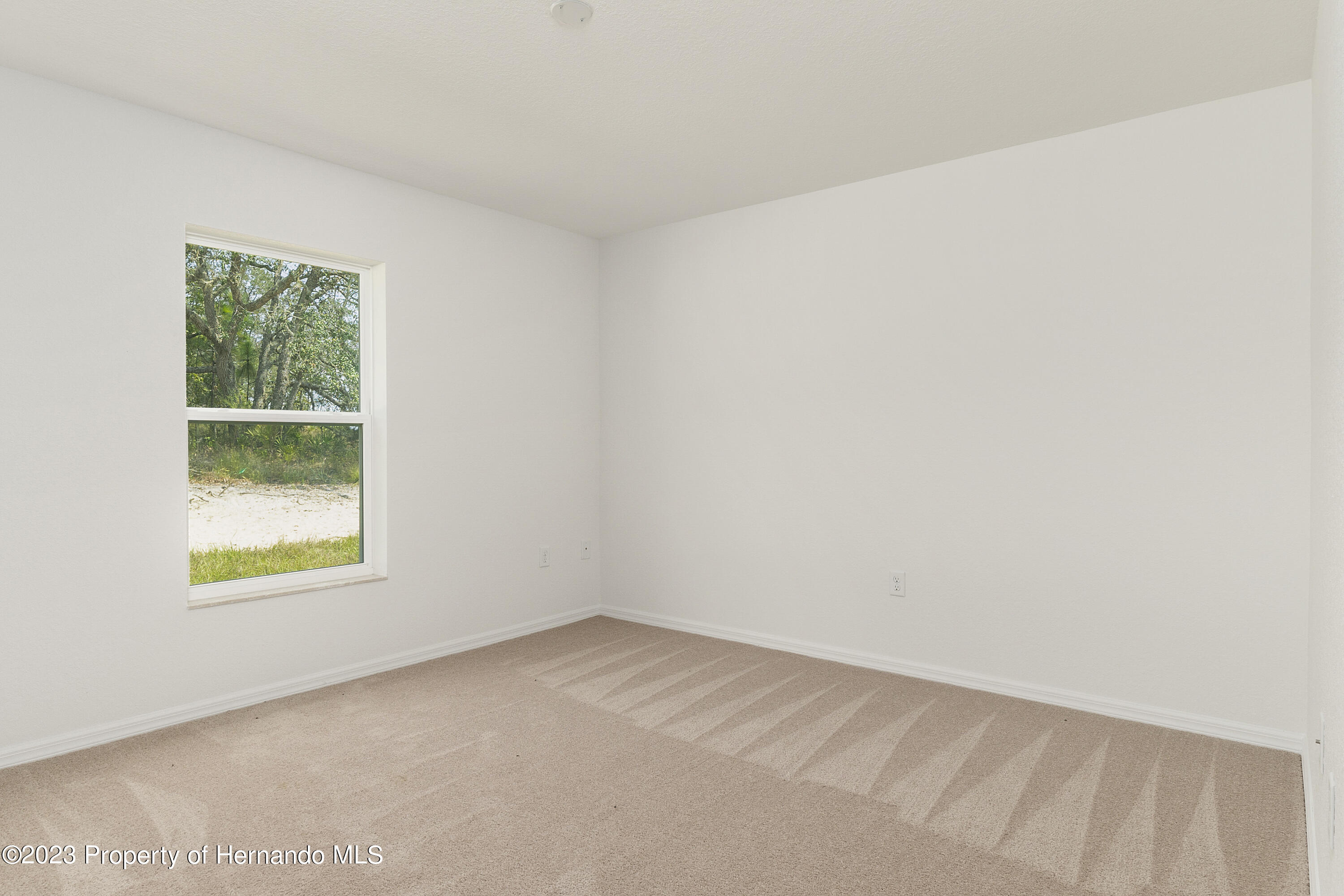 8433 Nightingale Road Weeki Wachee, FL 34613 - Photo 17 of 23 an empty room with a window