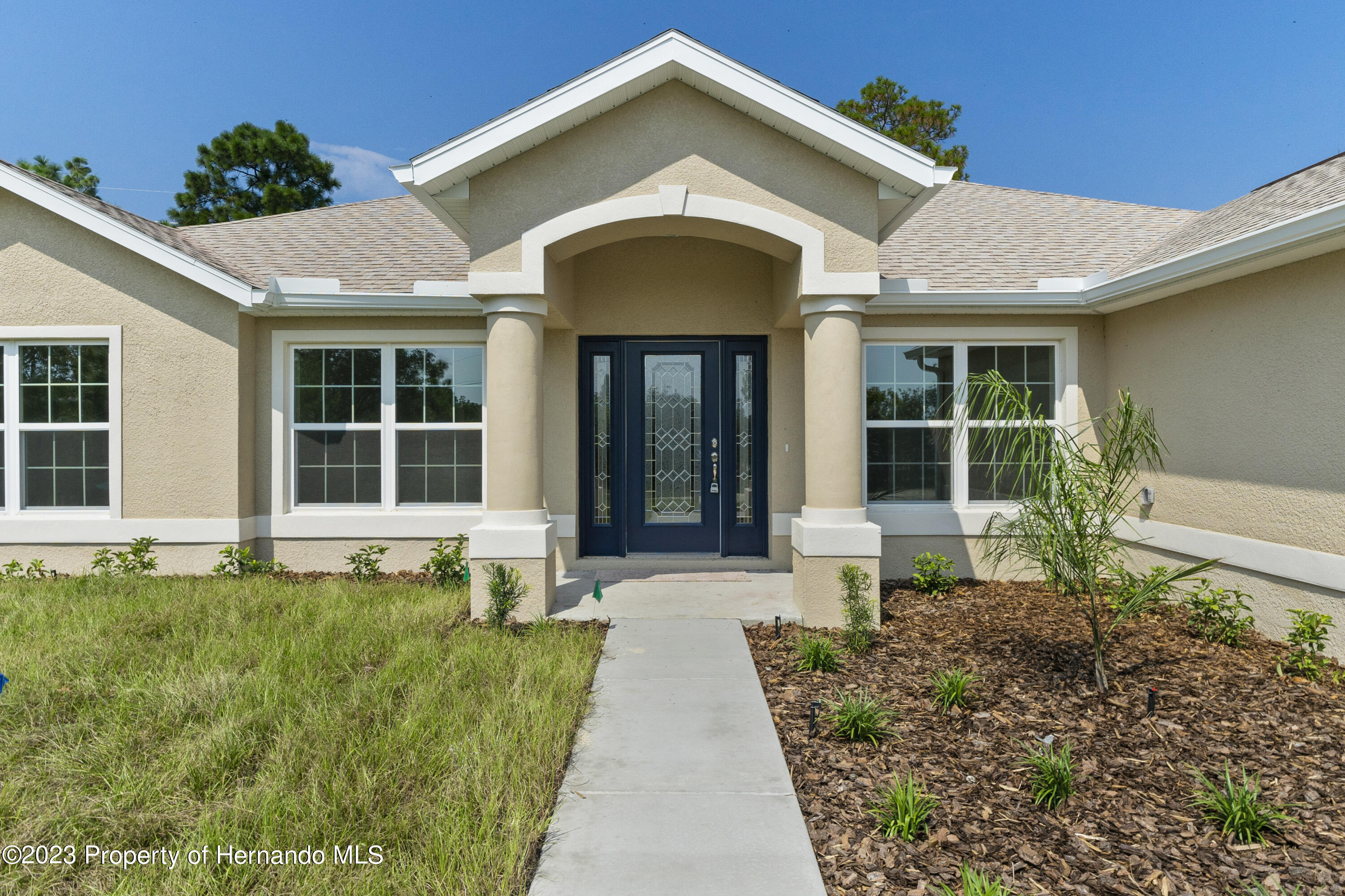 8433 Nightingale Road Weeki Wachee, FL 34613 - Photo 2 of 23 a front view of a house with a yard
