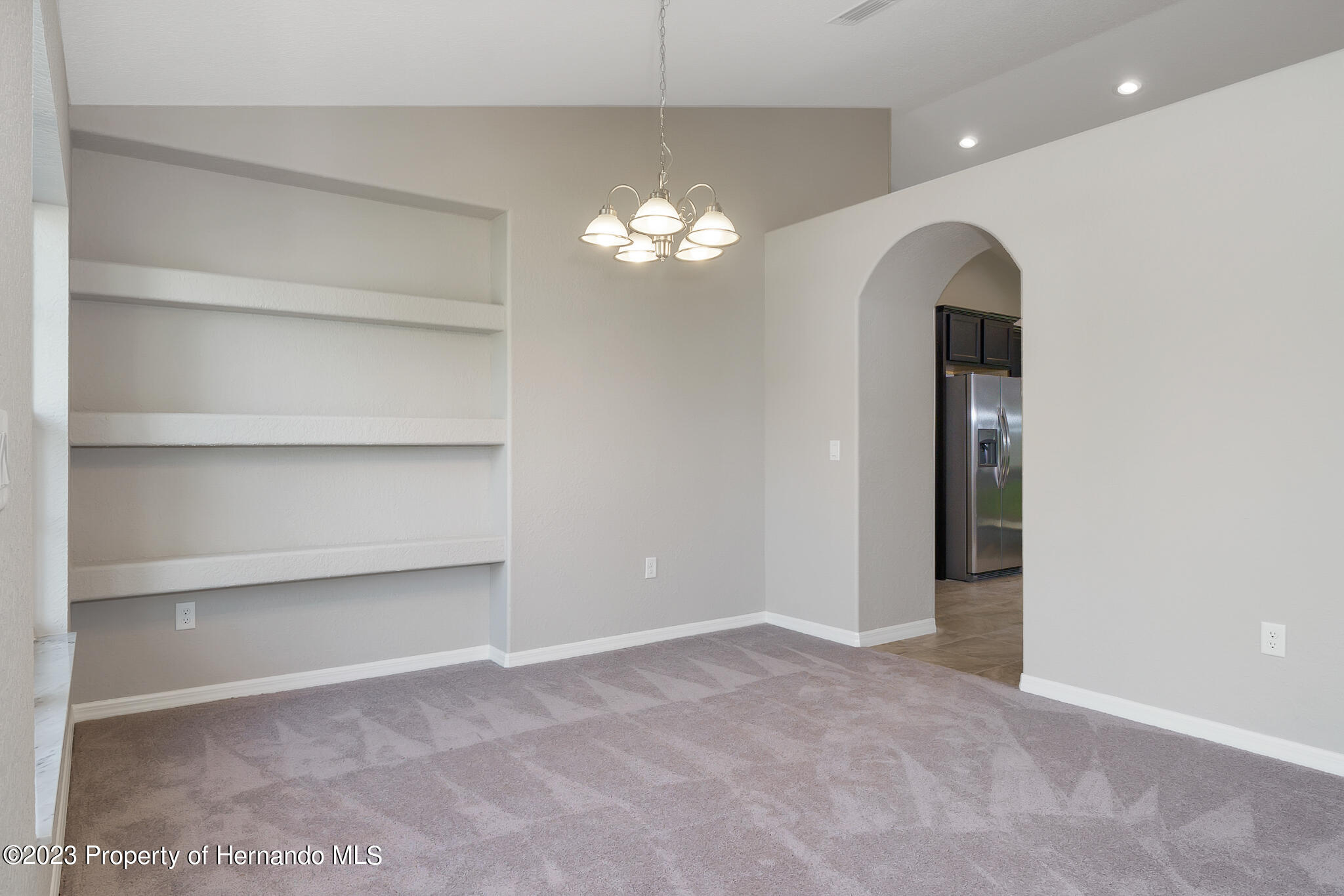 8433 Nightingale Road Weeki Wachee, FL 34613 - Photo 5 of 23 a view of empty room with a ceiling fan