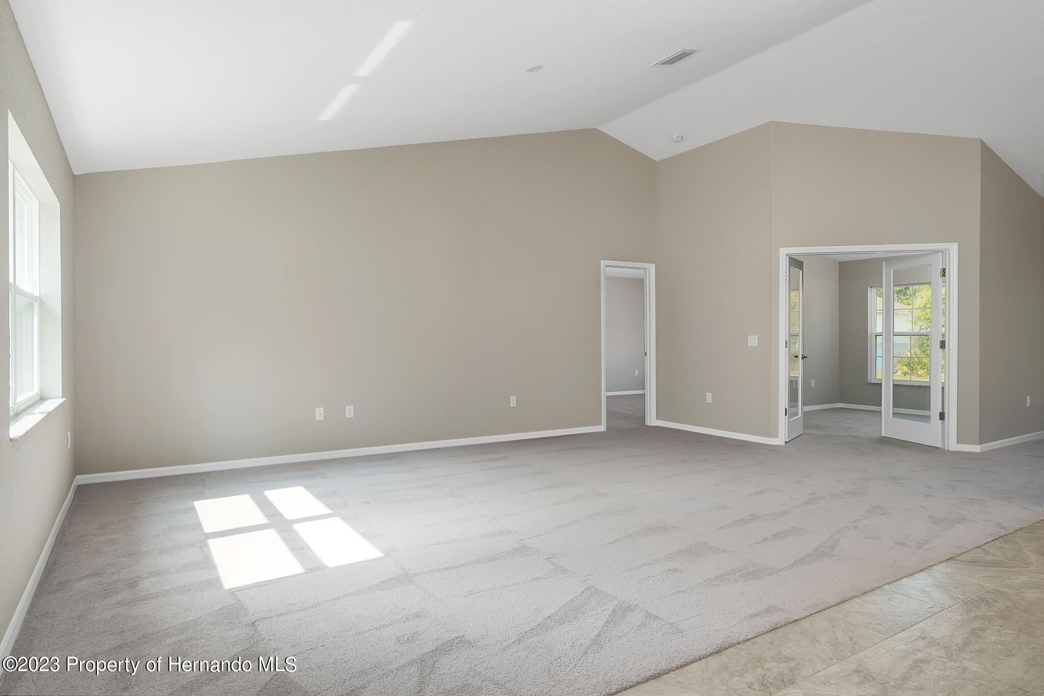 8433 Nightingale Road Weeki Wachee, FL 34613 - Photo 6 of 23 an empty room with windows