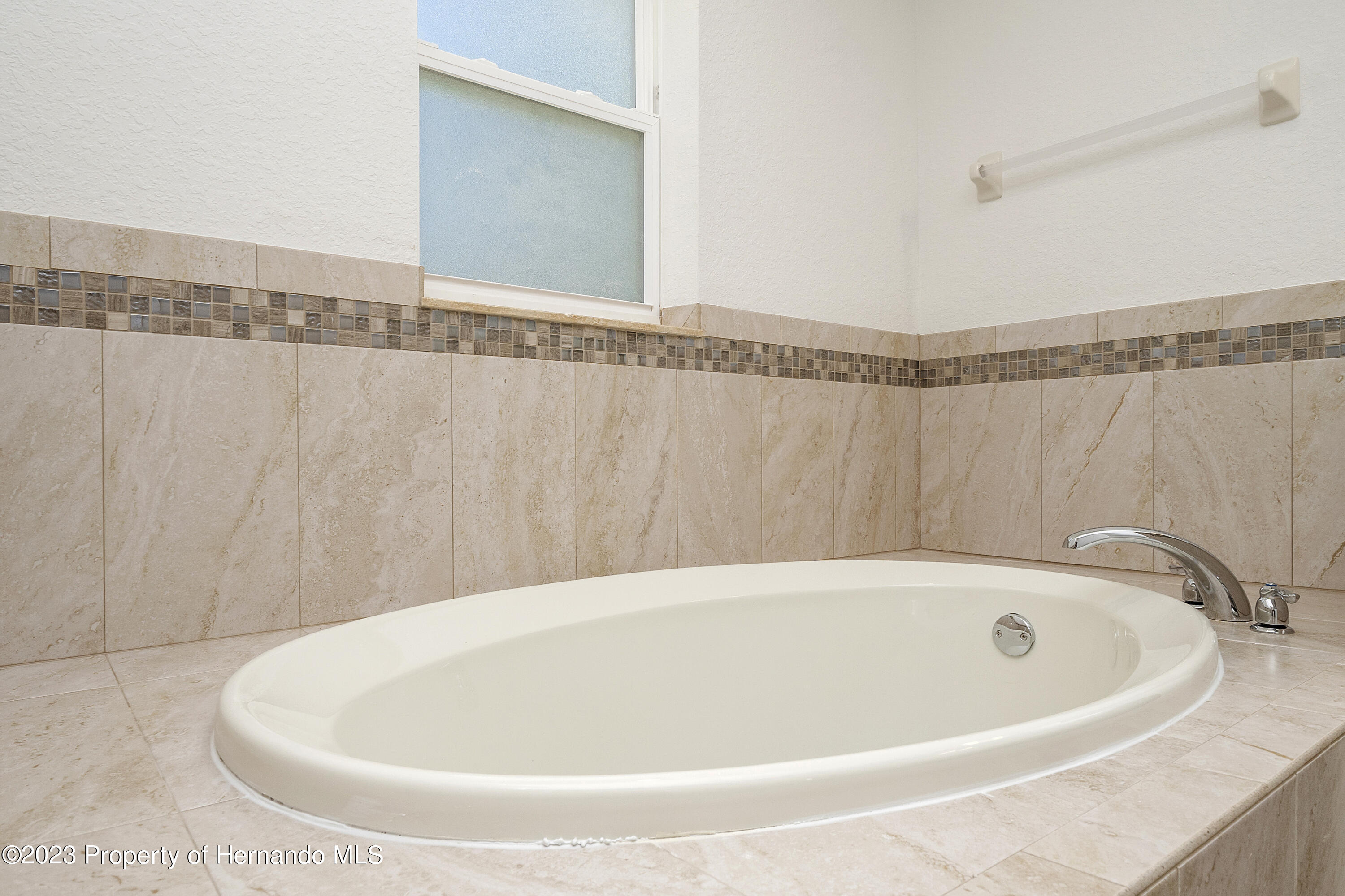 8433 Nightingale Road Weeki Wachee, FL 34613 - Photo 8 of 23 a white bath tub sitting in a bathroom