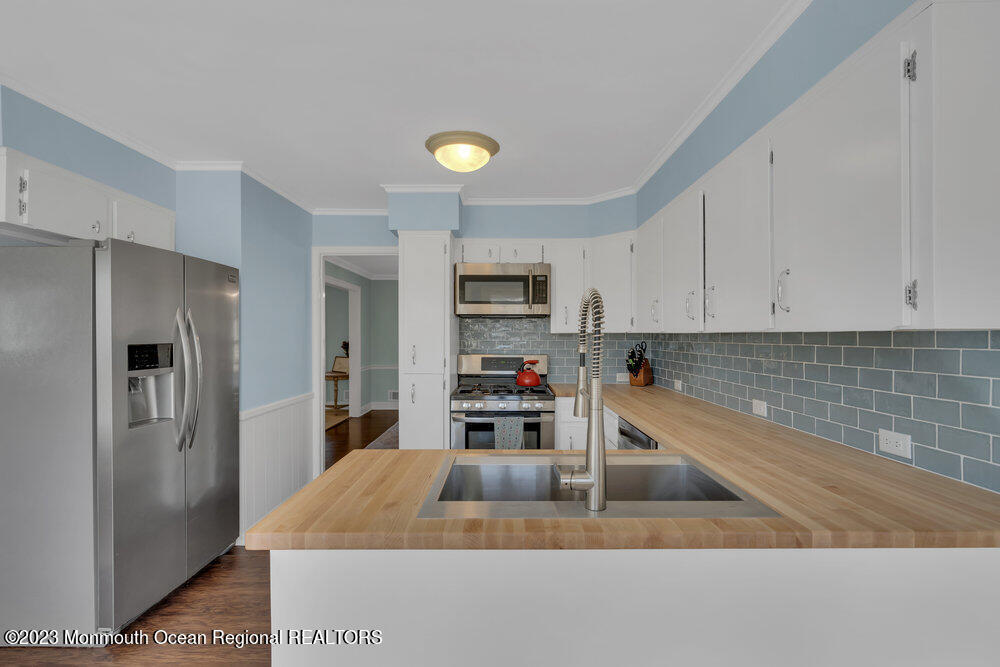 210 Richdale Road Colts Neck, NJ 07722 - Photo 12 of 40 a kitchen with a refrigerator and a sink