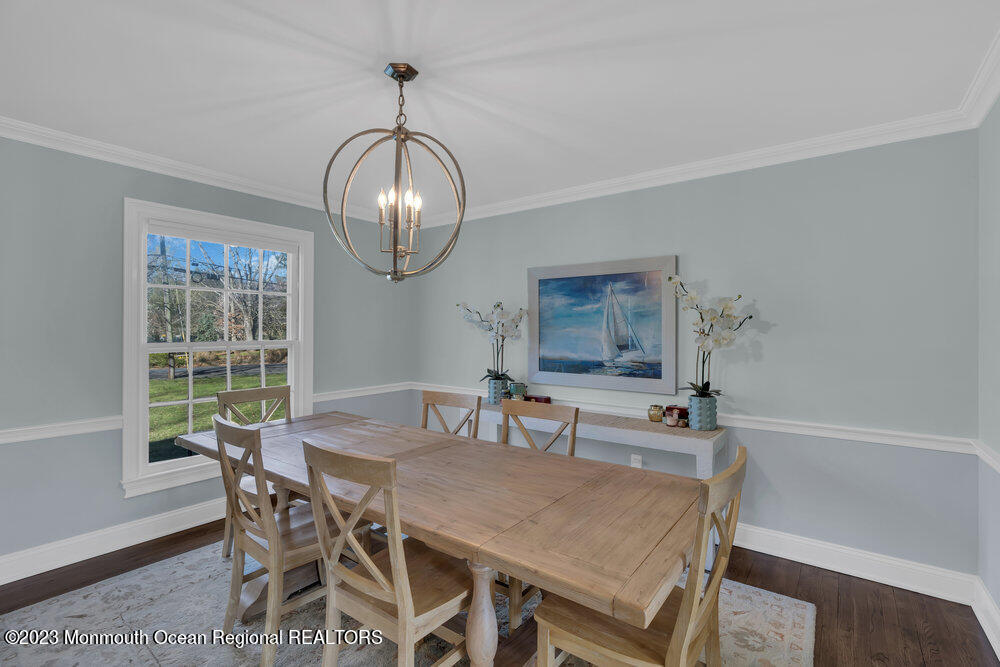 210 Richdale Road Colts Neck, NJ 07722 - Photo 18 of 40 a view of a dining room with furniture a chandelier and wooden floor