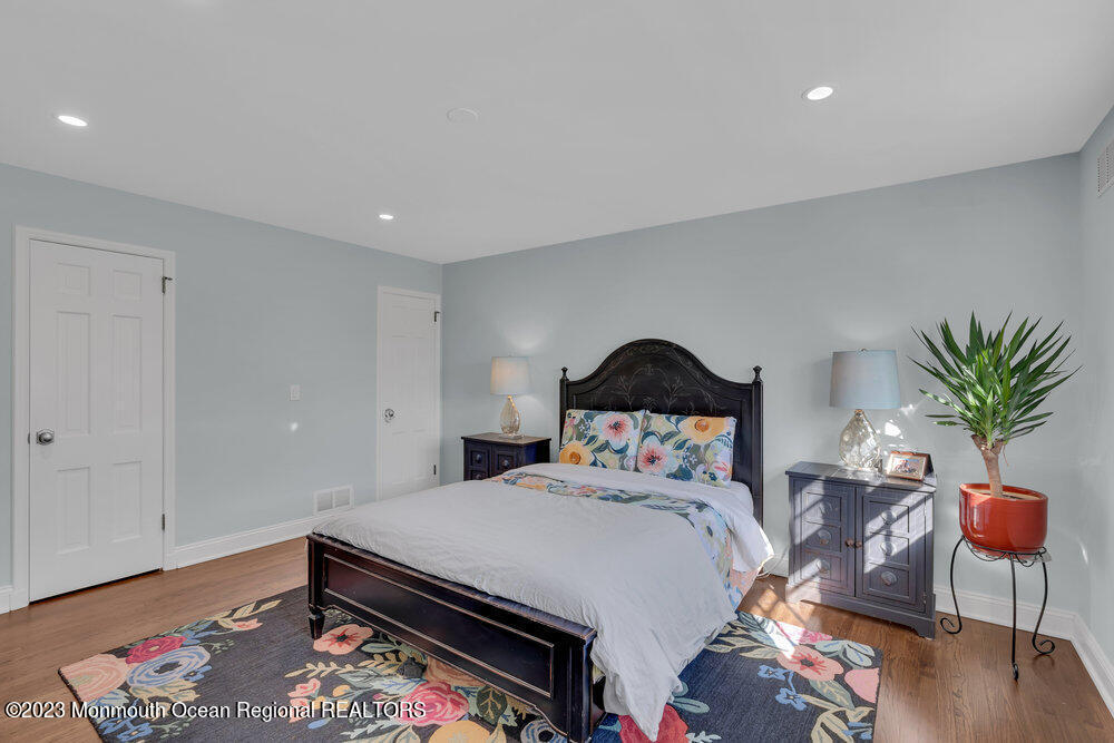 210 Richdale Road Colts Neck, NJ 07722 - Photo 26 of 40 a bedroom with a bed and a potted plant