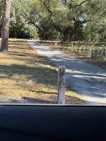 a view of swimming pool with a yard from a sink