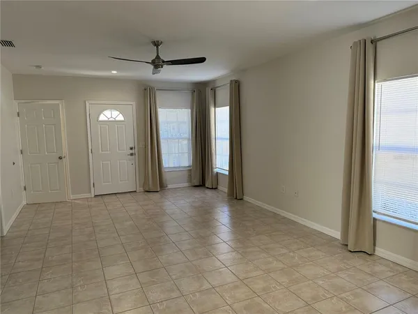 an empty room that has a mirror in it