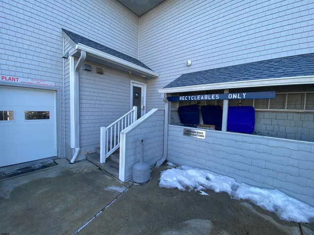 a view of a patio with table and chairs potted plants