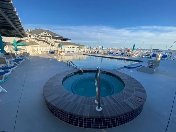 a view of a swimming pool with furniture