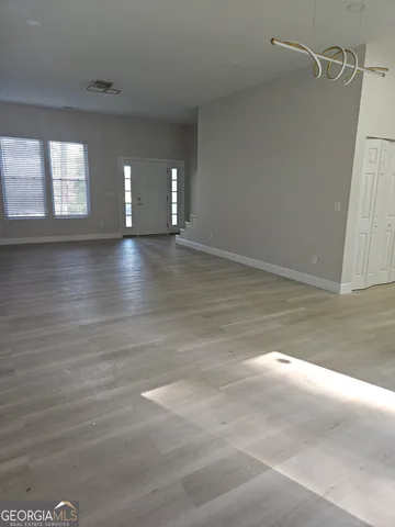 a view of a livingroom with wooden floor and window
