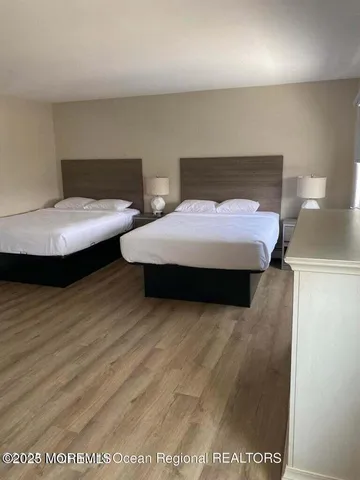 a bedroom with a bed and a night stand