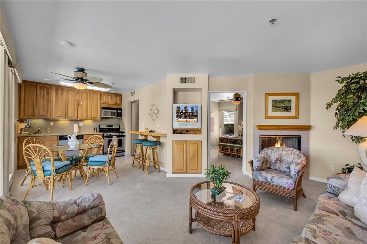 1555 North Chaparral Road, Unit 323 Palm Springs, CA 92262 - Photo 11 of 29 a living room with furniture potted plant and a fireplace