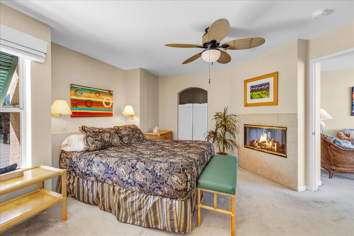 1555 North Chaparral Road, Unit 323 Palm Springs, CA 92262 - Photo 14 of 29 a bedroom with a bed and a chandelier