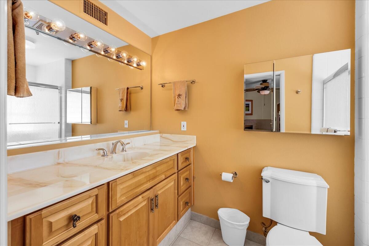 1555 North Chaparral Road, Unit 323 Palm Springs, CA 92262 - Photo 17 of 29 a bathroom with a toilet sink and mirror