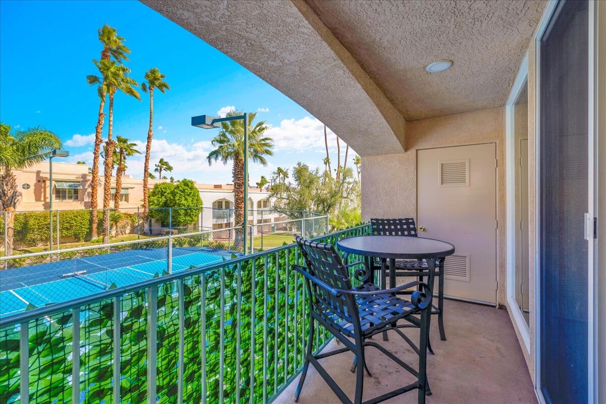 1555 North Chaparral Road, Unit 323 Palm Springs, CA 92262 - Photo 21 of 29 a view of an outdoor dining space with a table and chairs