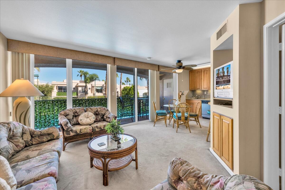 1555 North Chaparral Road, Unit 323 Palm Springs, CA 92262 - Photo 3 of 29 a living room with furniture and a large window