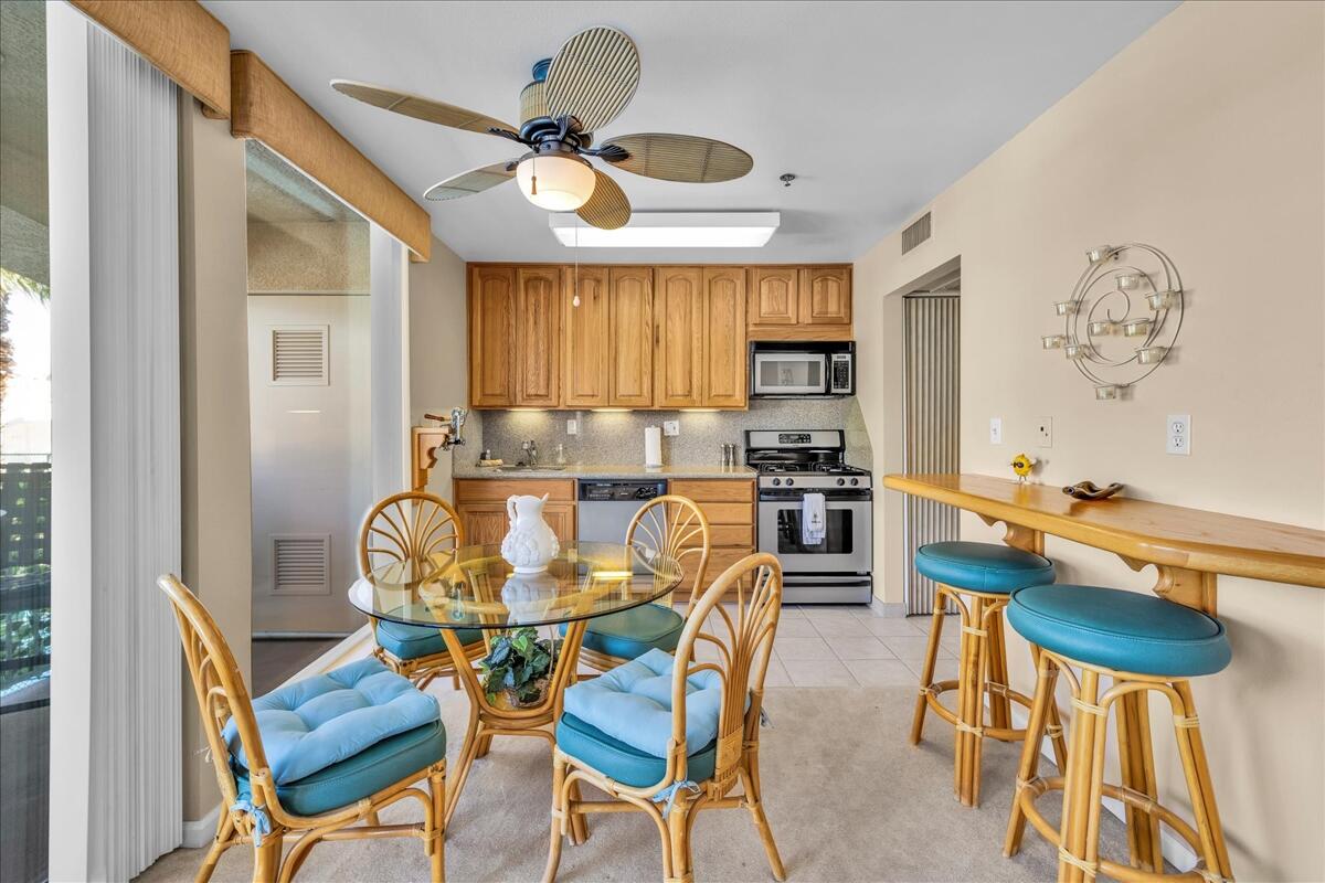 1555 North Chaparral Road, Unit 323 Palm Springs, CA 92262 - Photo 7 of 29 a view of a dining room with furniture and a chandelier