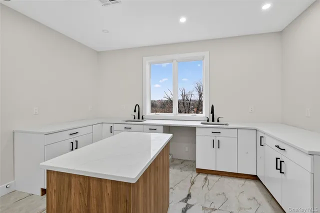 a kitchen with sink cabinets and window