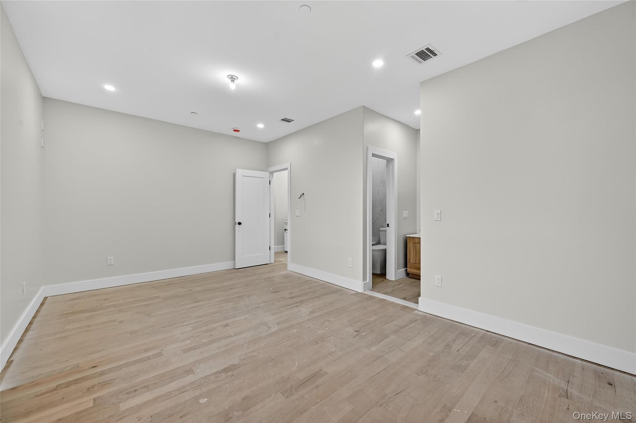6 Milla Lane Spring Valley, NY 10977 - Photo 18 of 49 an empty room with wooden floor and natural light