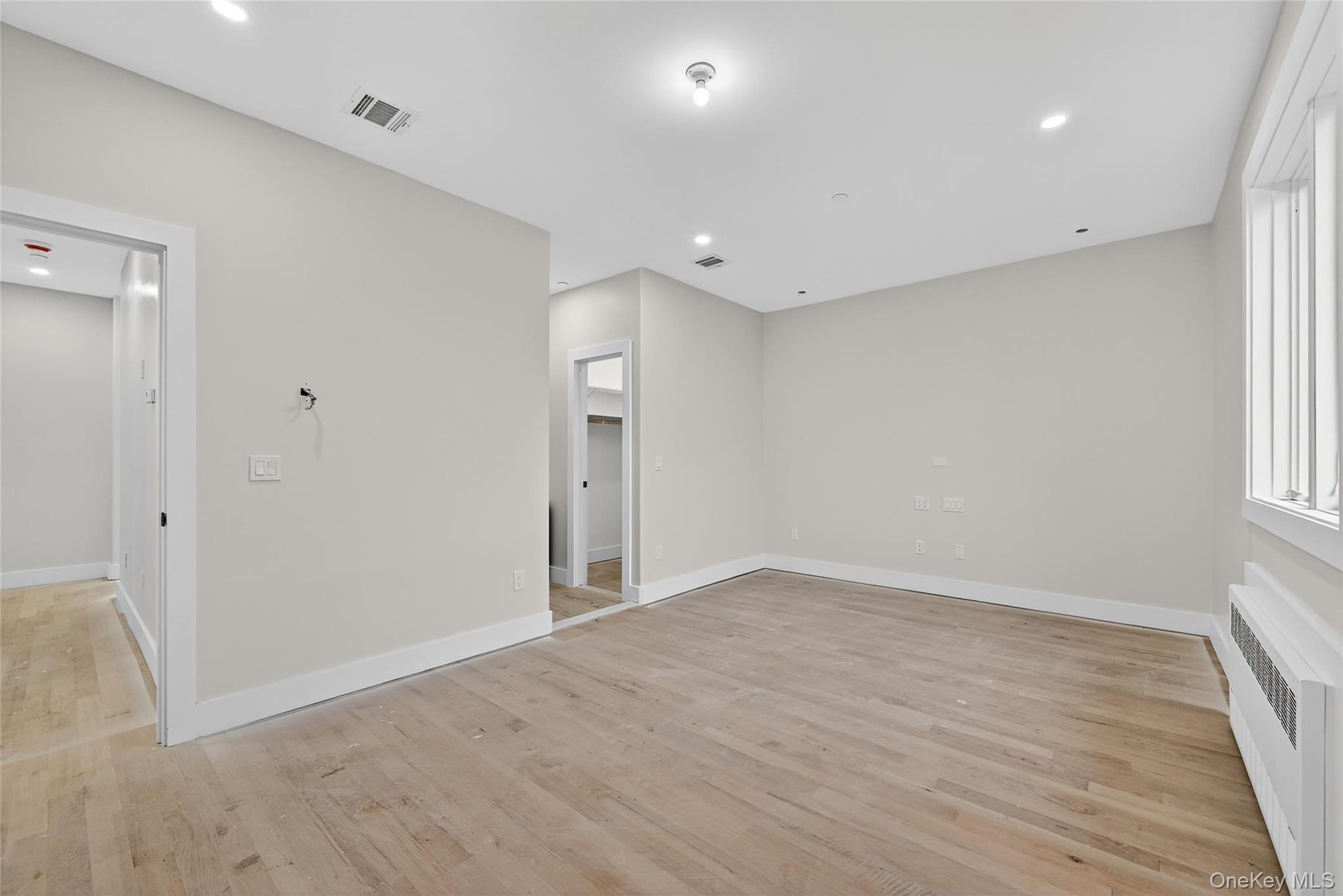 6 Milla Lane Spring Valley, NY 10977 - Photo 20 of 49 wooden floor in an empty room with a window