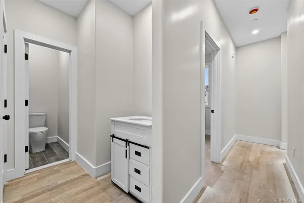 a white toilet sitting next to a white sink