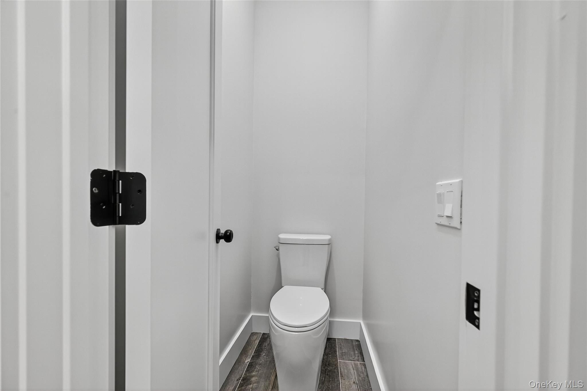 6 Milla Lane Spring Valley, NY 10977 - Photo 25 of 49 a white toilet sitting next to a white sink