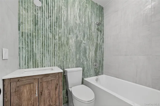 a bathroom with a sink a toilet and bathtub