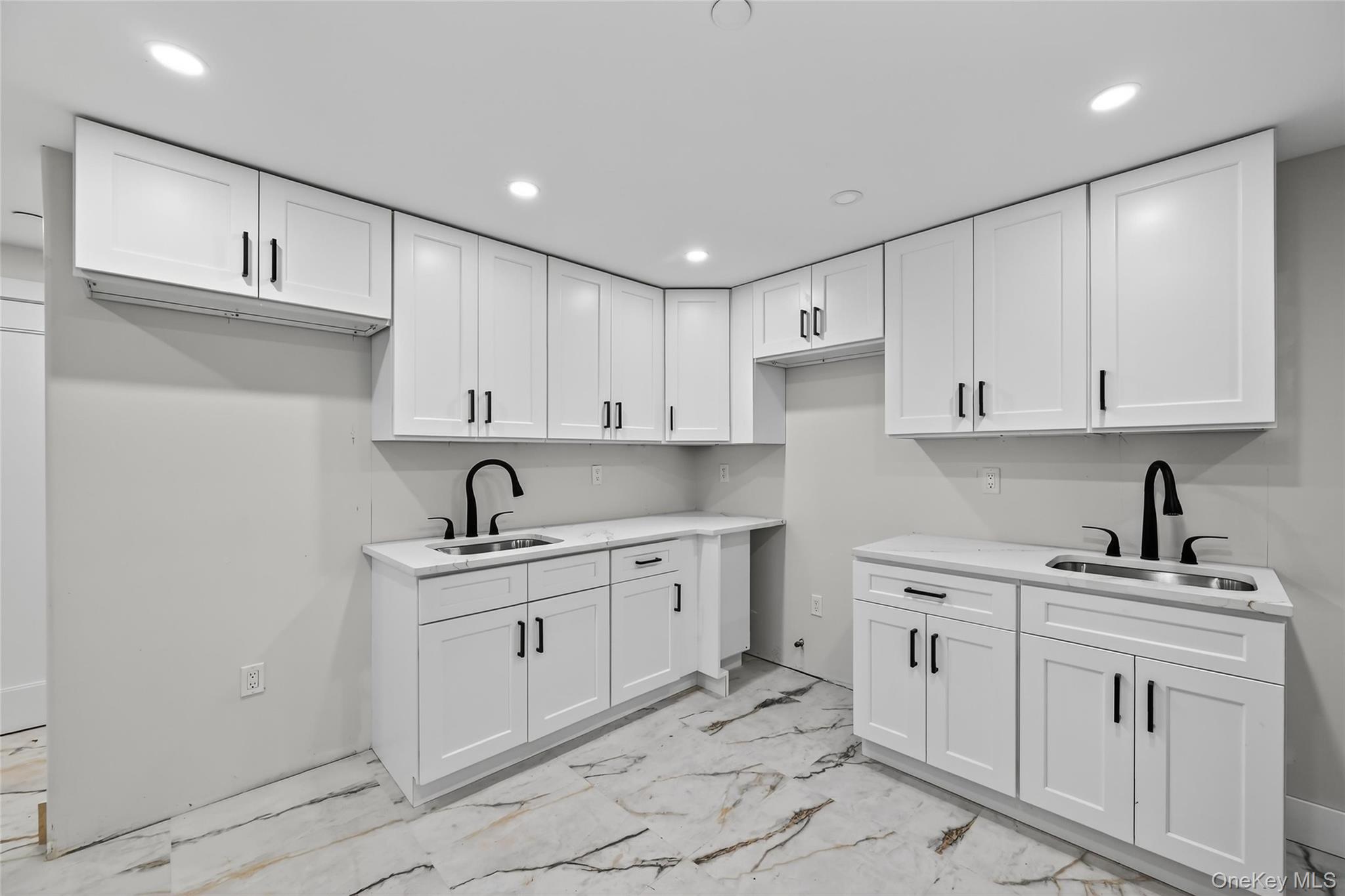 6 Milla Lane Spring Valley, NY 10977 - Photo 36 of 49 a kitchen with white cabinets appliances and sink