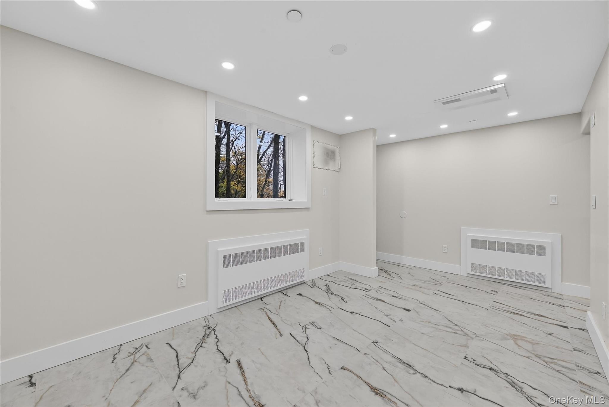 6 Milla Lane Spring Valley, NY 10977 - Photo 40 of 49 an empty room with wooden floor and windows