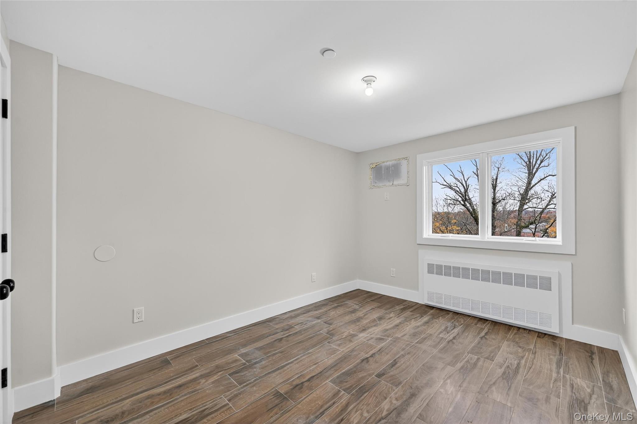 6 Milla Lane Spring Valley, NY 10977 - Photo 42 of 49 wooden floor in an empty room with a window