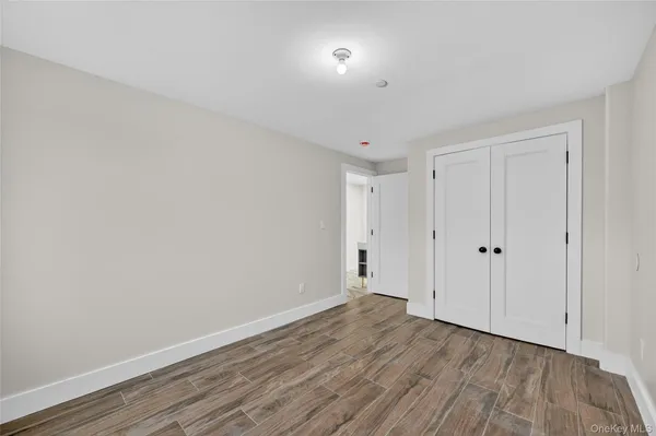 a view of a room with wooden floor