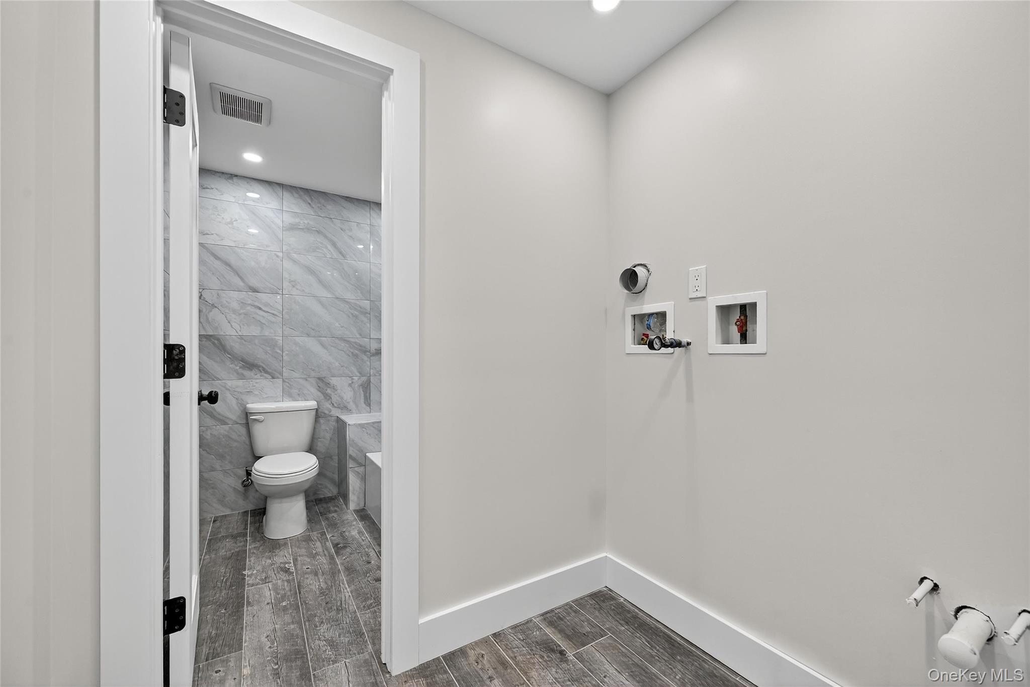 6 Milla Lane Spring Valley, NY 10977 - Photo 46 of 49 a bathroom with a granite countertop toilet and a sink