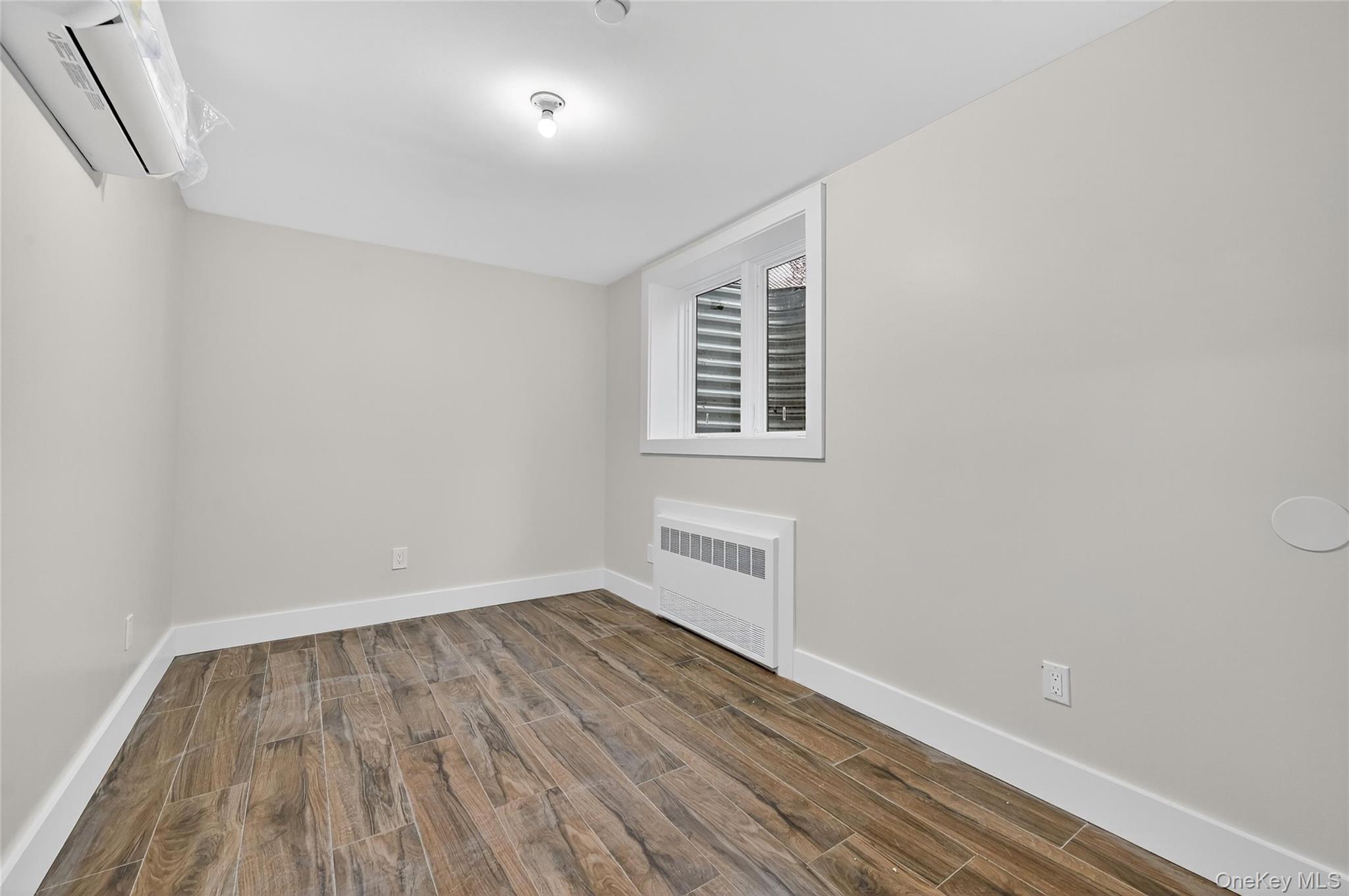 6 Milla Lane Spring Valley, NY 10977 - Photo 48 of 49 wooden floor in an empty room with a window