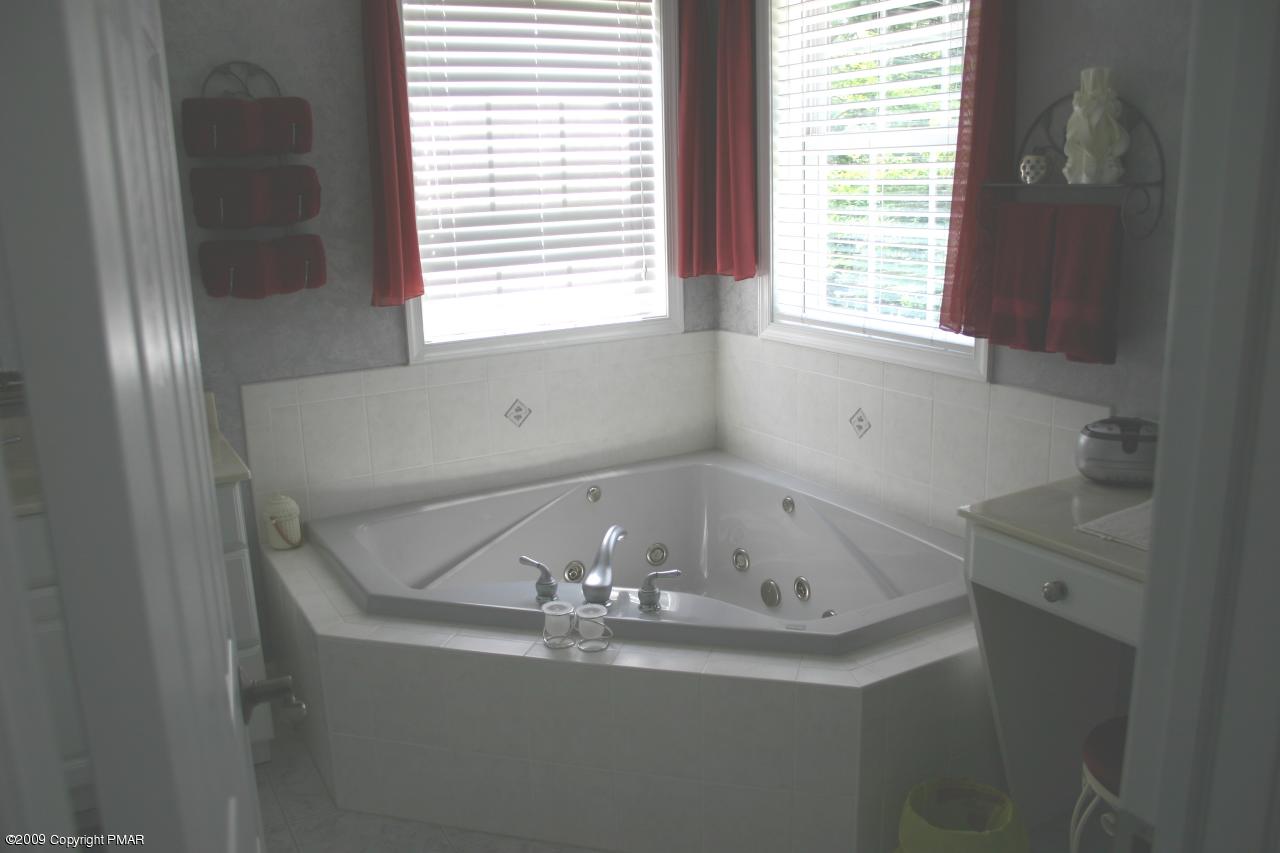 2189 Spruce Cabin Road Cresco, PA 18326 - Photo 11 of 13 a bath tub sitting in a bathroom next to a window